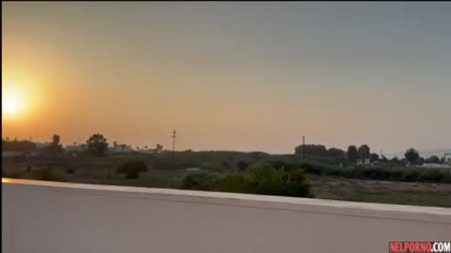 Big-assed girl fucks her guy with a sunset view
